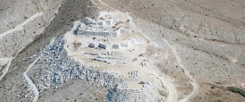 Terraced natural stone quarry with blocks cut from the hillside